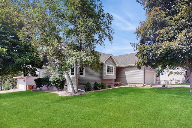4855 Coachlight Dr, West Des Moines, IA 50265 - view of property exterior with a garage, a yard, a shingled roof, and driveway