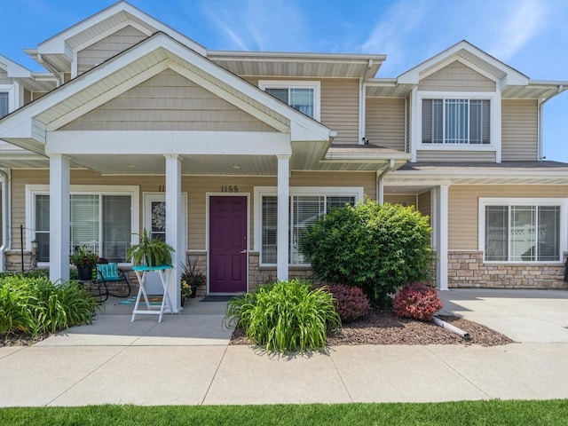 1155 NE 7th Ln, Ankeny, IA 50021 - townhome / multi-family property with stone siding and a porch