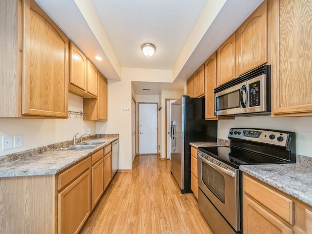 1155 NE 7th Ln, Ankeny, IA 50021 - kitchen with appliances with stainless steel finishes, light wood-style flooring, light countertops, and light brown cabinetry