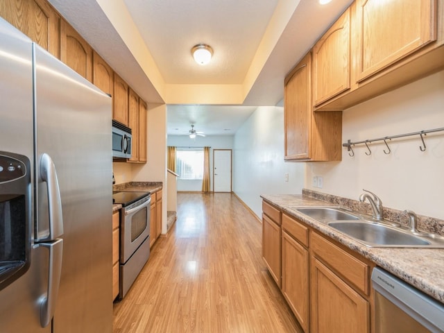 1155 NE 7th Ln, Ankeny, IA 50021 - kitchen featuring stainless steel appliances, light wood finished floors, a ceiling fan, and light countertops