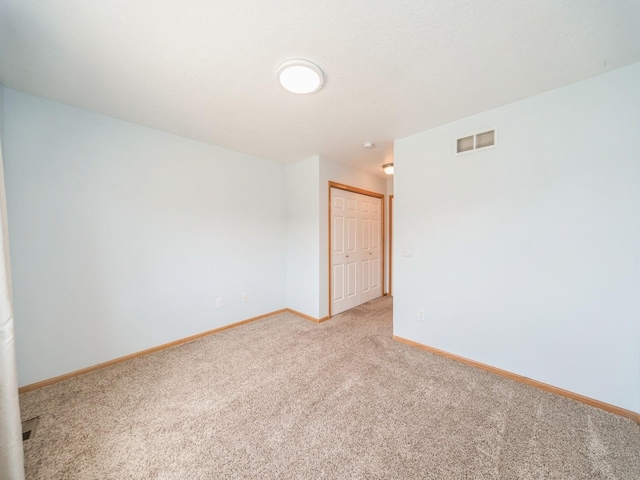 1155 NE 7th Ln, Ankeny, IA 50021 - spare room featuring light colored carpet and baseboards