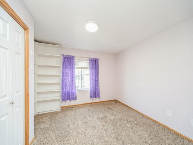 1155 NE 7th Ln, Ankeny, IA 50021 - carpeted empty room featuring baseboards