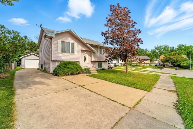 2434 SE 18th Ct, Des Moines, IA 50320 - raised ranch with a front yard, an outdoor structure, a garage, and concrete driveway