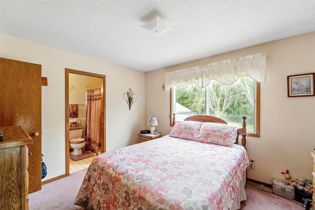 2434 SE 18th Ct, Des Moines, IA 50320 - bedroom with carpet, a textured ceiling, and connected bathroom