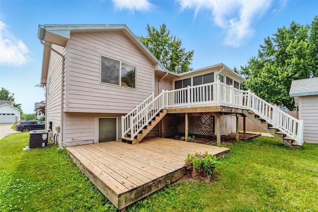 2434 SE 18th Ct, Des Moines, IA 50320 - rear view of house featuring stairs, a sunroom, a wooden deck, and a lawn