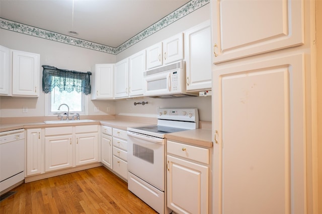 1422 SE Waywin Dr, Ankeny, IA 50021 - kitchen featuring white appliances, light wood-type flooring, light countertops, and white cabinetry