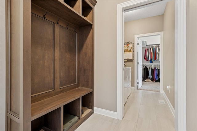 800 NE Badger Ln, Waukee, IA 50263 - mudroom with baseboards and separate washer and dryer