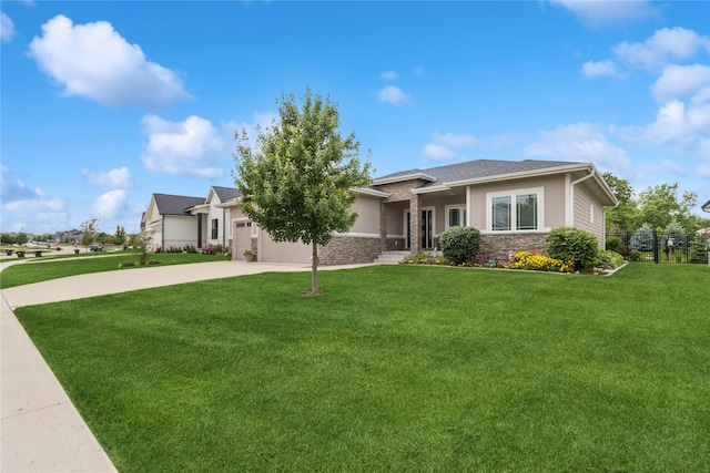 800 NE Badger Ln, Waukee, IA 50263 - view of front of house with stone siding, concrete driveway, a front lawn, a garage, and stucco siding