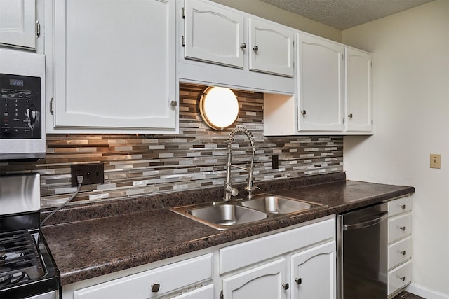 1213 NW Greenwood St, Ankeny, IA 50023 - kitchen featuring appliances with stainless steel finishes, white cabinetry, dark countertops, tasteful backsplash, and a textured ceiling