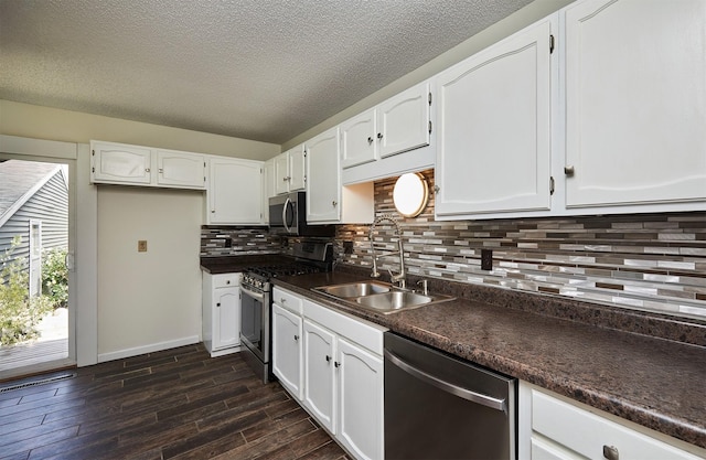 1213 NW Greenwood St, Ankeny, IA 50023 - kitchen with stainless steel appliances, dark countertops, white cabinetry, tasteful backsplash, and a textured ceiling