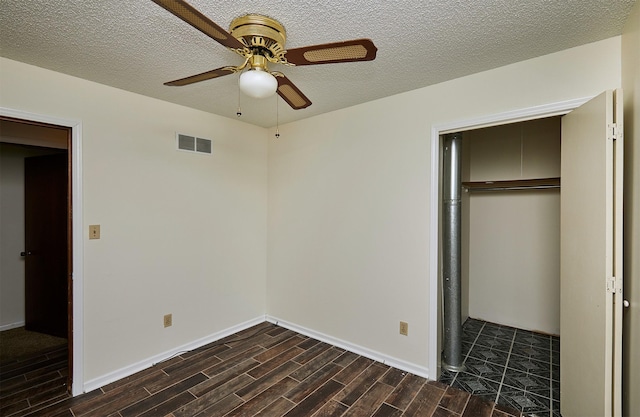 1213 NW Greenwood St, Ankeny, IA 50023 - unfurnished bedroom with dark wood-style floors, a closet, a textured ceiling, and ceiling fan