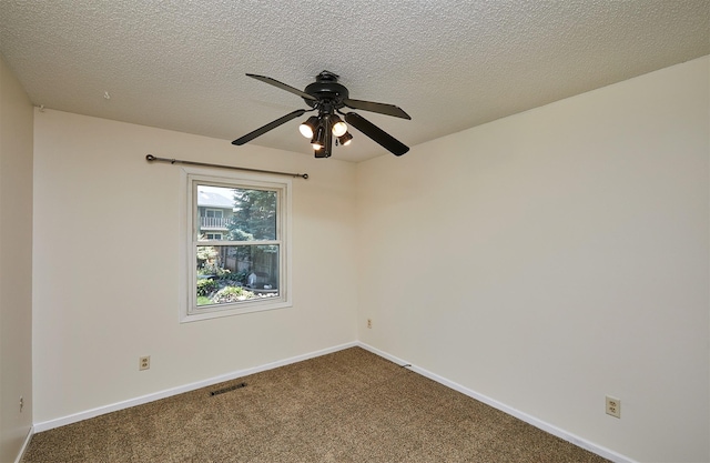 1213 NW Greenwood St, Ankeny, IA 50023 - unfurnished room with a ceiling fan, dark carpet, and a textured ceiling