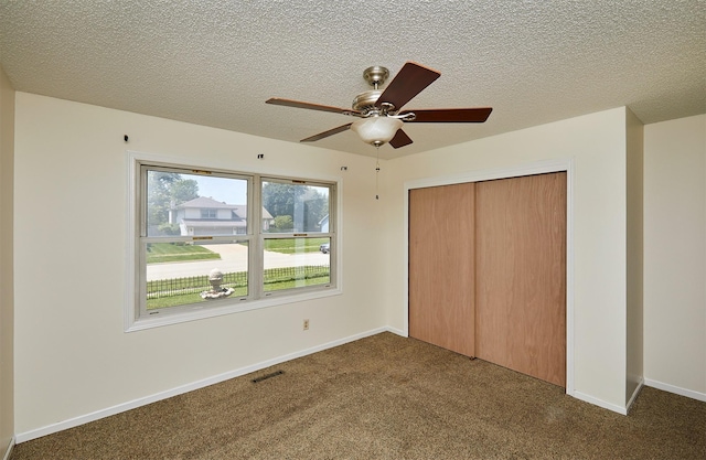 1213 NW Greenwood St, Ankeny, IA 50023 - unfurnished bedroom with carpet floors, a closet, a textured ceiling, and ceiling fan