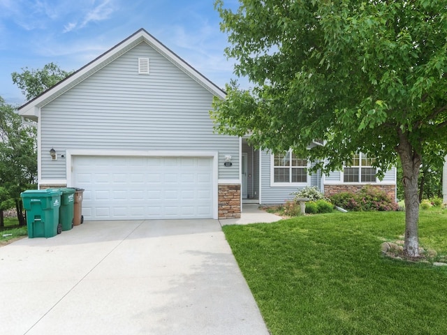 2227 4th Ave SE, Altoona, IA 50009 - view of front of house with concrete driveway, a front yard, stone siding, and a garage