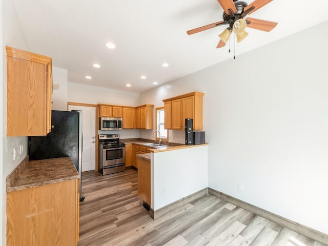 2227 4th Ave SE, Altoona, IA 50009 - kitchen with appliances with stainless steel finishes, a peninsula, light wood-type flooring, recessed lighting, and a ceiling fan