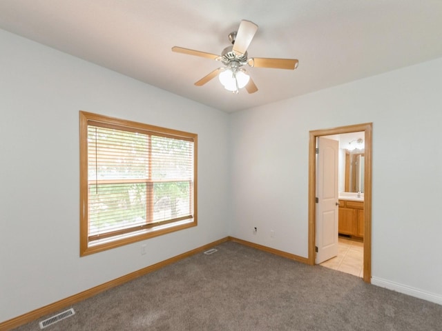 2227 4th Ave SE, Altoona, IA 50009 - empty room with light carpet and a ceiling fan