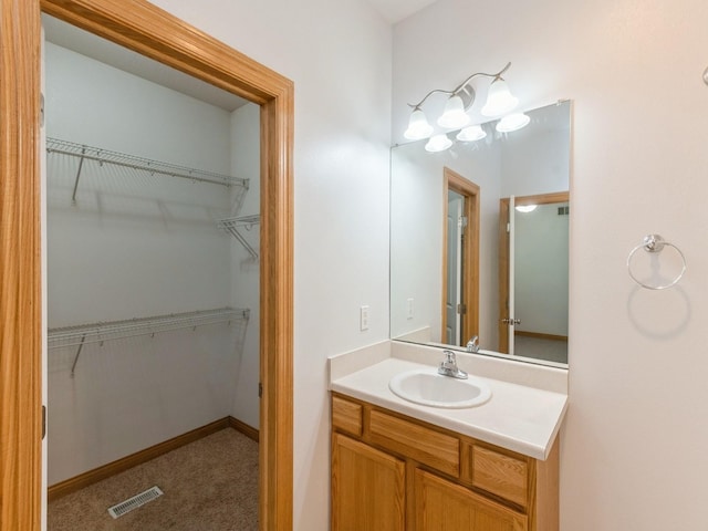 2227 4th Ave SE, Altoona, IA 50009 - bathroom featuring vanity and a spacious closet