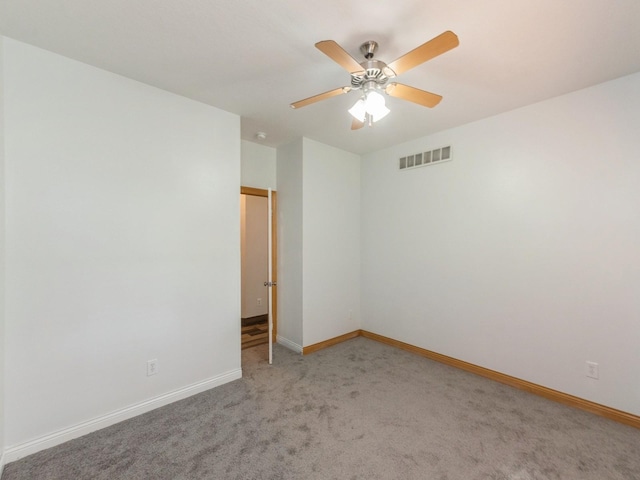 2227 4th Ave SE, Altoona, IA 50009 - spare room featuring light carpet and a ceiling fan