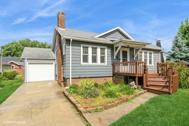 2417 Maryland Pike, Des Moines, IA 50310 - bungalow featuring a chimney, a wooden deck, driveway, an attached garage, and a front lawn