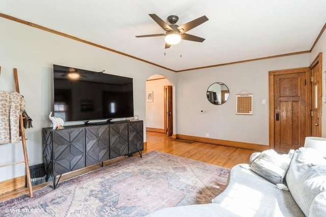 2417 Maryland Pike, Des Moines, IA 50310 - living room featuring arched walkways, wood finished floors, a ceiling fan, and ornamental molding