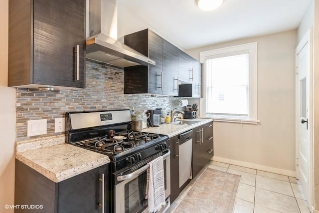 2417 Maryland Pike, Des Moines, IA 50310 - kitchen with appliances with stainless steel finishes, wall chimney exhaust hood, tasteful backsplash, light countertops, and light tile patterned floors