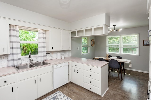 715 Maple St, Waukee, IA 50263 - kitchen featuring white dishwasher, light countertops, a peninsula, white cabinetry, and a chandelier