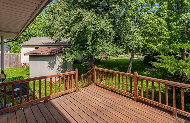 715 Maple St, Waukee, IA 50263 - wooden terrace featuring a shed and a lawn