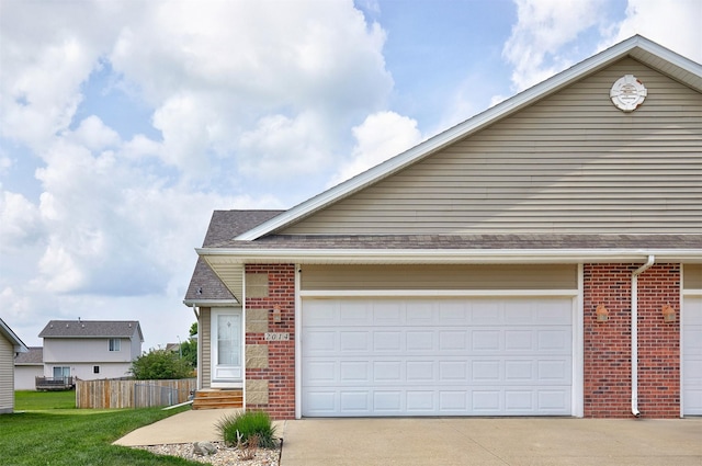2014 Vista View Dr, Granger, IA 50109 - view of front of property featuring brick siding, driveway, and an attached garage