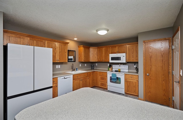 2014 Vista View Dr, Granger, IA 50109 - kitchen featuring white appliances, light countertops, a textured ceiling, and brown cabinetry