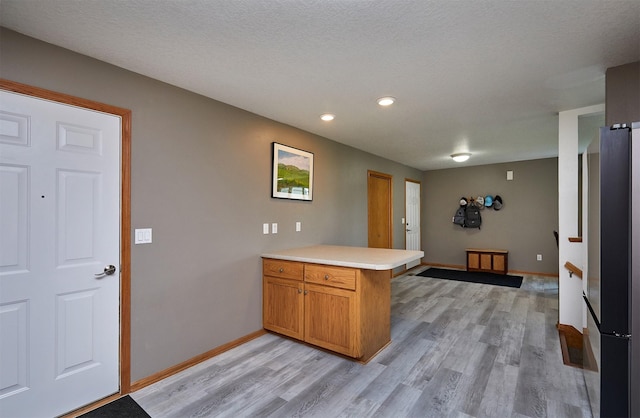 2014 Vista View Dr, Granger, IA 50109 - kitchen featuring a peninsula, freestanding refrigerator, light wood-style floors, light countertops, and recessed lighting