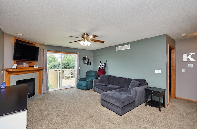 2014 Vista View Dr, Granger, IA 50109 - carpeted living area featuring a ceiling fan, a fireplace with flush hearth, and a textured ceiling