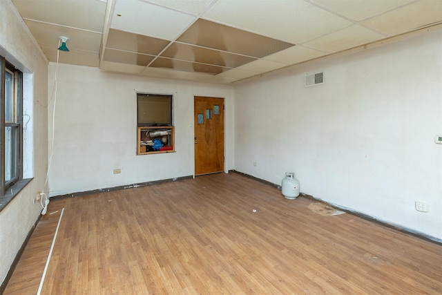 3120 Amherst St, Des Moines, IA 50313 - empty room with wood finished floors and a drop ceiling