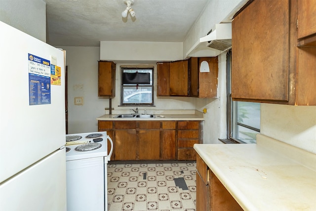 3120 Amherst St, Des Moines, IA 50313 - kitchen with white appliances, brown cabinets, light countertops, and light flooring