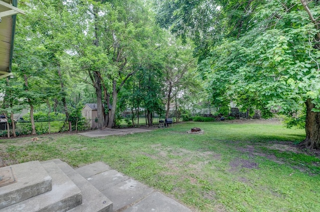 2736 College Ave, Des Moines, IA 50311 - fenced backyard with a storage shed and a patio