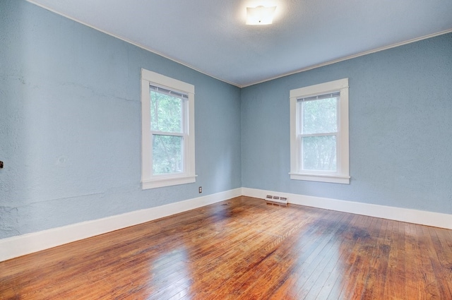 2736 College Ave, Des Moines, IA 50311 - empty room with hardwood / wood-style flooring and crown molding