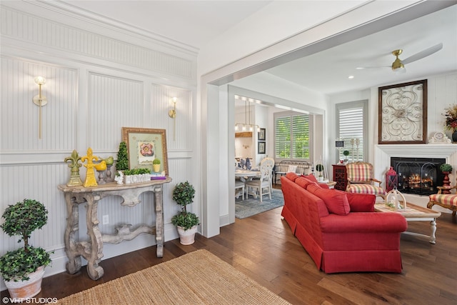 1811 SW Oak St, Ankeny, IA 50023 - living room featuring wood finished floors, a lit fireplace, and a ceiling fan