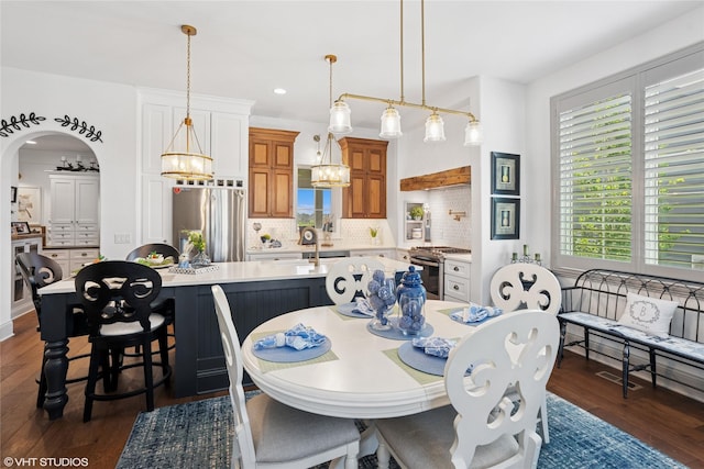1811 SW Oak St, Ankeny, IA 50023 - dining area with dark wood-type flooring, recessed lighting, a chandelier, and arched walkways