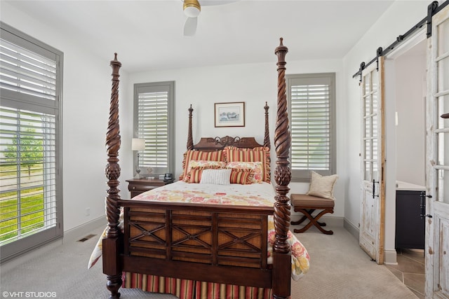 1811 SW Oak St, Ankeny, IA 50023 - bedroom featuring a barn door, multiple windows, and light colored carpet