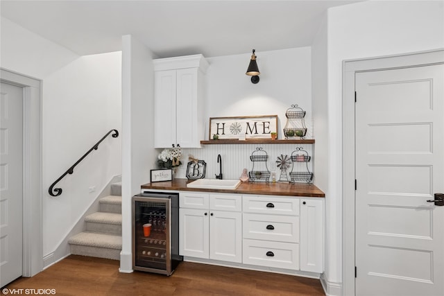 1811 SW Oak St, Ankeny, IA 50023 - indoor wet bar with wine cooler, dark wood finished floors, and stairway