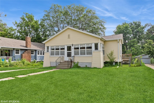 737 38th St, Des Moines, IA 50312 - view of front of house with a front yard and a shingled roof