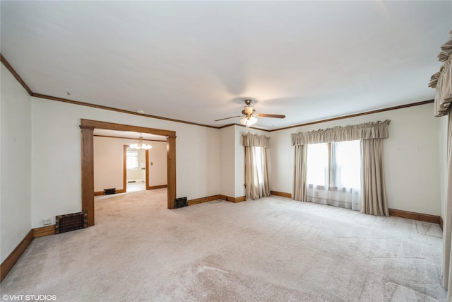 737 38th St, Des Moines, IA 50312 - unfurnished room featuring a chandelier, plenty of natural light, crown molding, light carpet, and ceiling fan