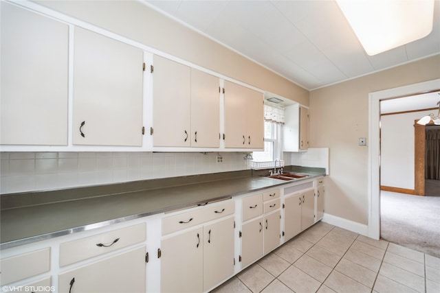 737 38th St, Des Moines, IA 50312 - kitchen with tasteful backsplash, light tile patterned flooring, and dark countertops