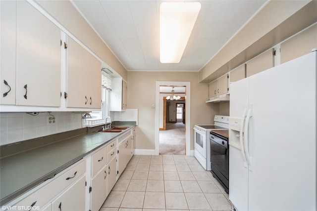737 38th St, Des Moines, IA 50312 - kitchen featuring white appliances, under cabinet range hood, a chandelier, light tile patterned floors, and decorative backsplash