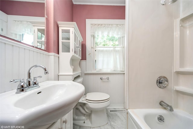 737 38th St, Des Moines, IA 50312 - bathroom with wainscoting, marble finish floors, and shower / bath combination