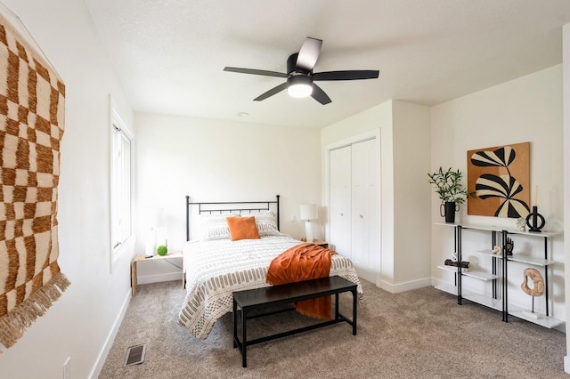 8501 NW Beaver Dr, Johnston, IA 50131 - bedroom with carpet flooring, ceiling fan, and a closet