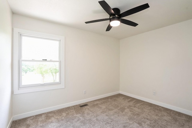 8501 NW Beaver Dr, Johnston, IA 50131 - carpeted spare room with baseboards and ceiling fan