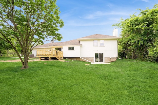 8501 NW Beaver Dr, Johnston, IA 50131 - back of house with a deck, a chimney, and a lawn
