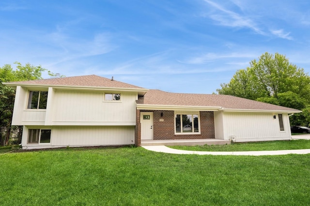 8501 NW Beaver Dr, Johnston, IA 50131 - tri-level home featuring a front yard and a shingled roof