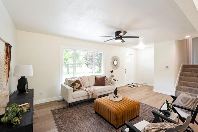 8501 NW Beaver Dr, Johnston, IA 50131 - living room with light wood finished floors, stairs, ceiling fan, and recessed lighting
