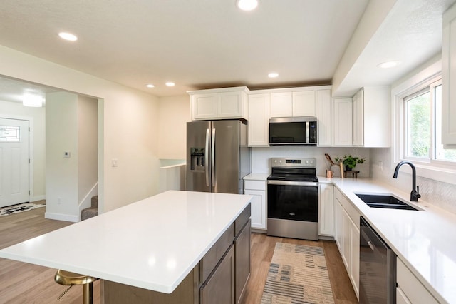8501 NW Beaver Dr, Johnston, IA 50131 - kitchen featuring appliances with stainless steel finishes, light wood-type flooring, recessed lighting, and light countertops